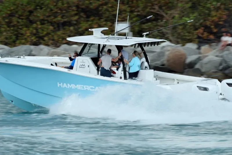 The Image of 2024 Hammer Yachts 35 speeding on water with passengers, showcasing sleek design and performance. - 0