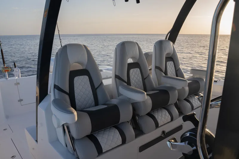 Slide: The Image of Luxury seating on 2024 Hammer Yachts 35, overlooking serene ocean at sunset. - 13