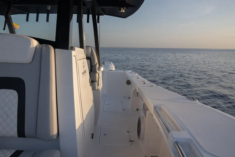 Slide: The Image of 2024 Hammer Yachts 35 model, sleek design, cruising on open water at sunset. - 14