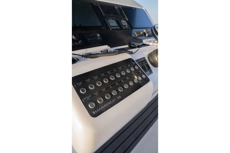 Slide: The Image of Control panel of 2024 Hammer Yachts 35, featuring labeled buttons and steering wheel. - 16