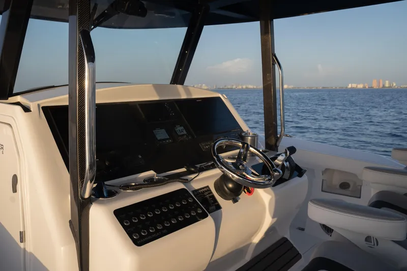 Slide: The Image of Helm of 2024 Hammer Yachts 35, featuring modern controls and ocean view. - 7
