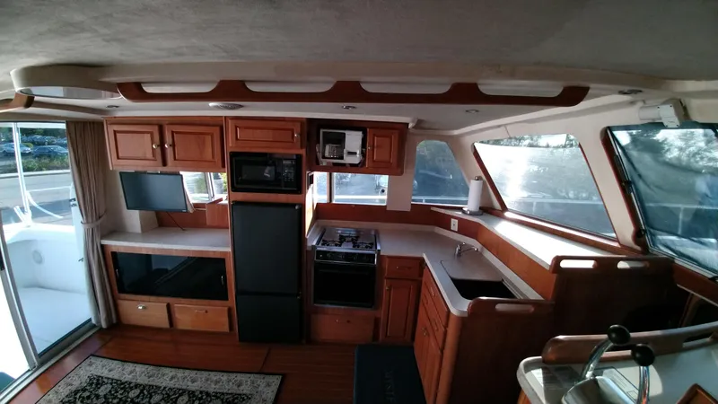 Slide: The Image of 1999 Mainship 350 Trawler interior with kitchen and appliances - 15