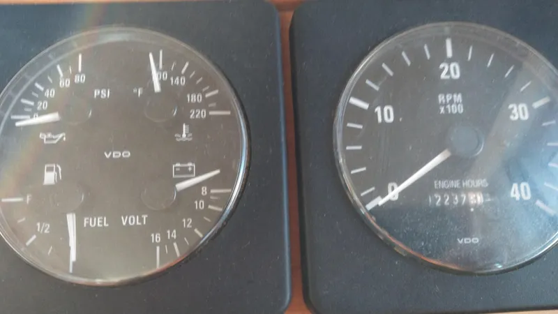 Slide: The Image of Close-up of 1999 Mainship 350 Trawler engine gauges showing fuel, voltage, RPM, and engine hours. - 22