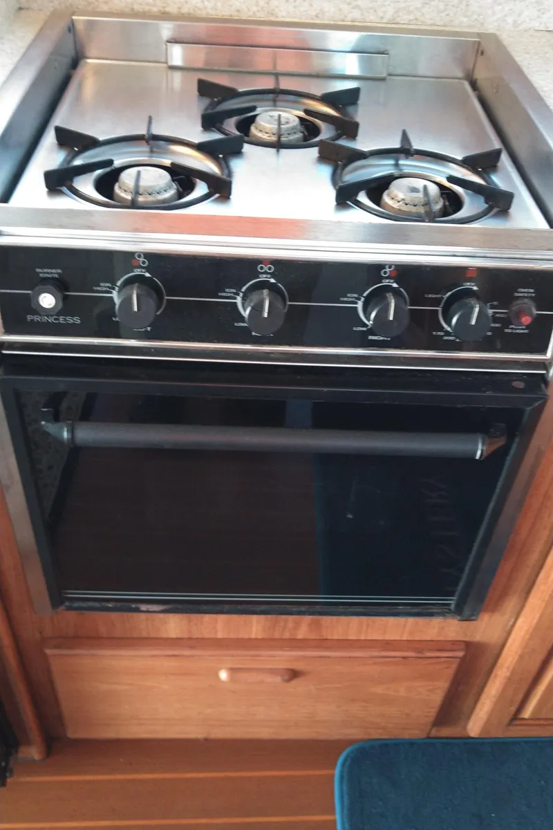 Slide: The Image of Stove and oven in a 1999 Mainship 350 Trawler kitchen. - 26