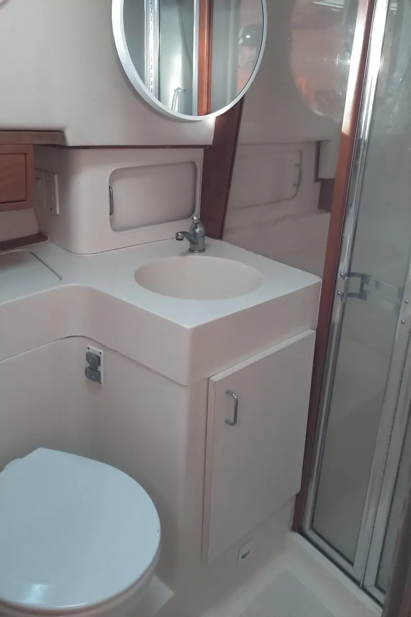 Slide: The Image of 1999 Mainship 350 Trawler bathroom with sink, toilet, and shower. - 38