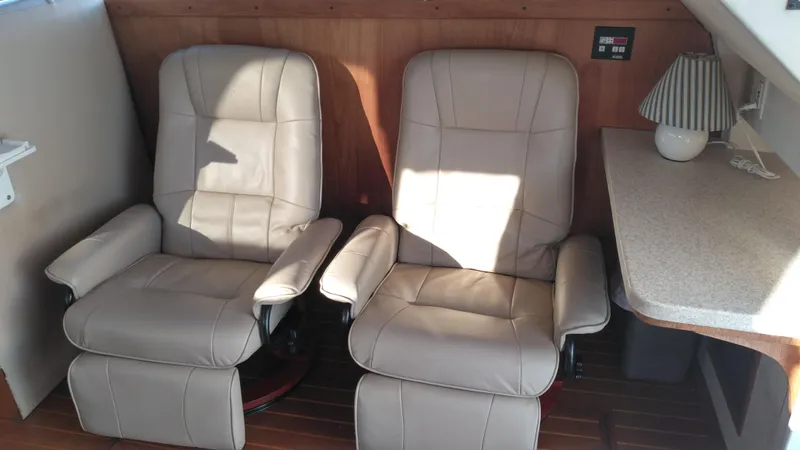Slide: The Image of Two beige leather recliners in the cabin of a 1999 Mainship 350 Trawler. - 41