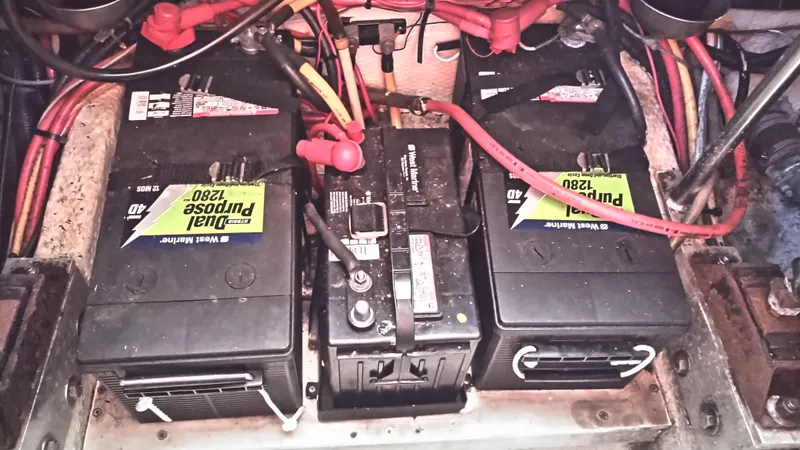 Slide: The Image of 1999 Mainship 350 Trawler battery compartment with dual purpose 1280 batteries. - 49