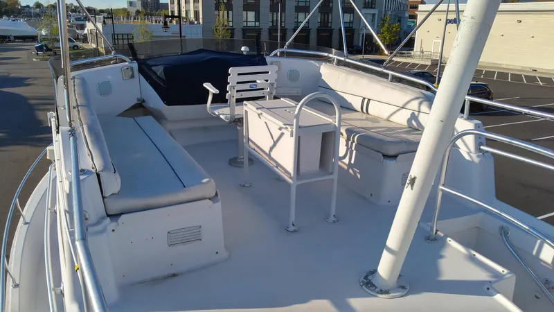 Slide: The Image of 1999 Mainship 350 Trawler upper deck with seating and table. - 8