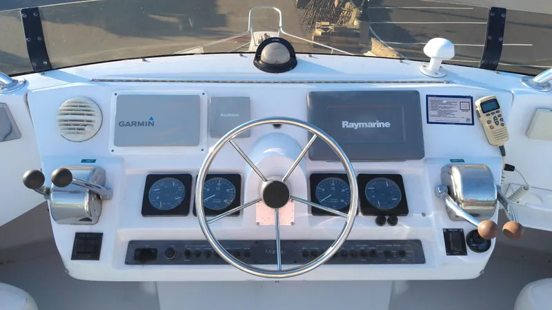 Slide: The Image of 1999 Mainship 350 Trawler helm with Garmin and Raymarine navigation systems. - 9