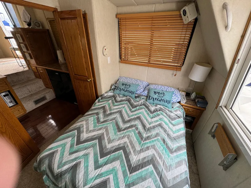 Slide: The Image of Cozy bedroom in 2008 Holiday Mansion 37 houseboat with chevron-patterned bedding and wooden blinds. - 21