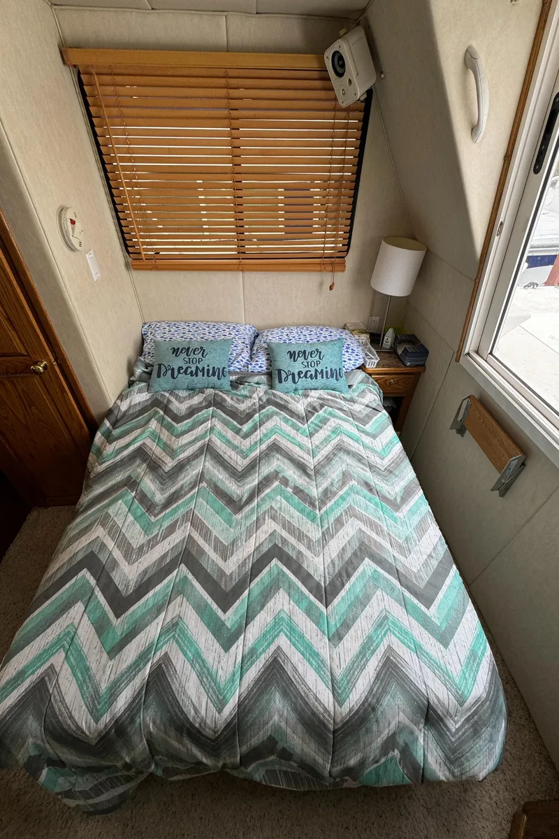 Slide: The Image of Cozy bedroom in 2008 Holiday Mansion 37 with chevron bedding and wooden blinds. - 23