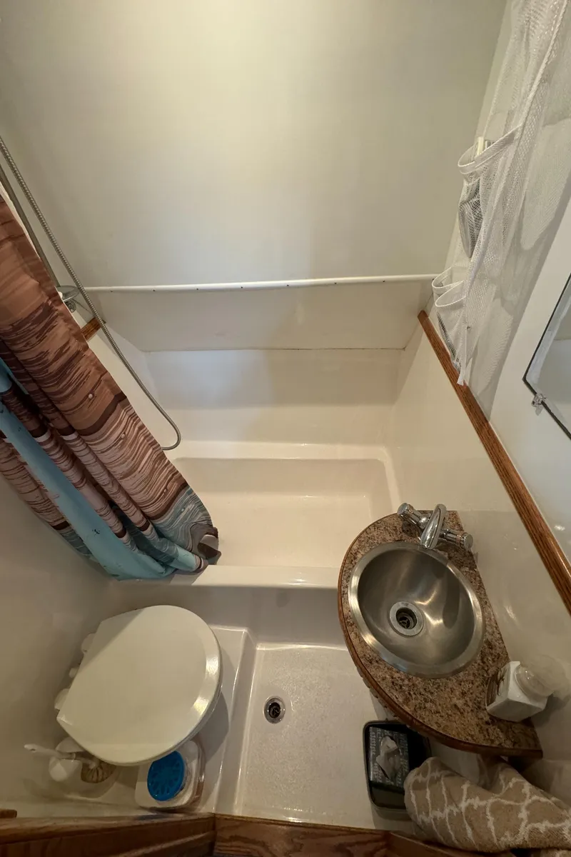 Slide: The Image of Compact bathroom in 2008 Holiday Mansion 37, featuring shower, toilet, and sink. - 25
