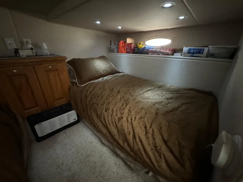 Slide: The Image of Cozy cabin interior of 2008 Holiday Mansion 37 with single bed and storage. - 28