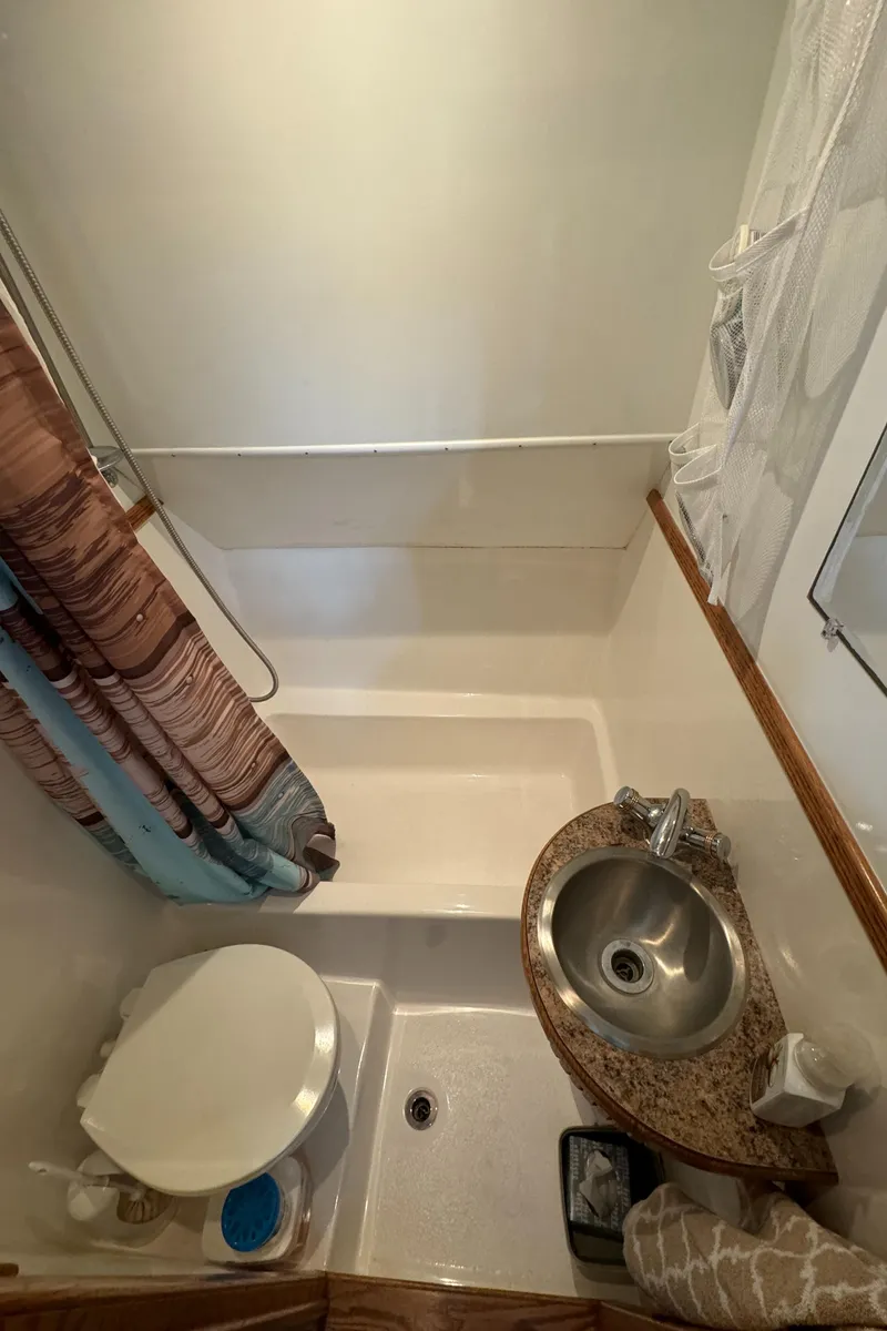Slide: The Image of Compact bathroom in 2008 Holiday Mansion 37 with shower, sink, and toilet. - 30