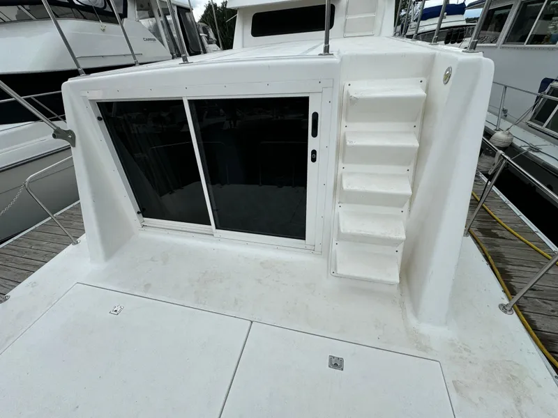 Slide: The Image of 2008 Holiday Mansion 37 boat deck with sliding glass door and stairs. - 6