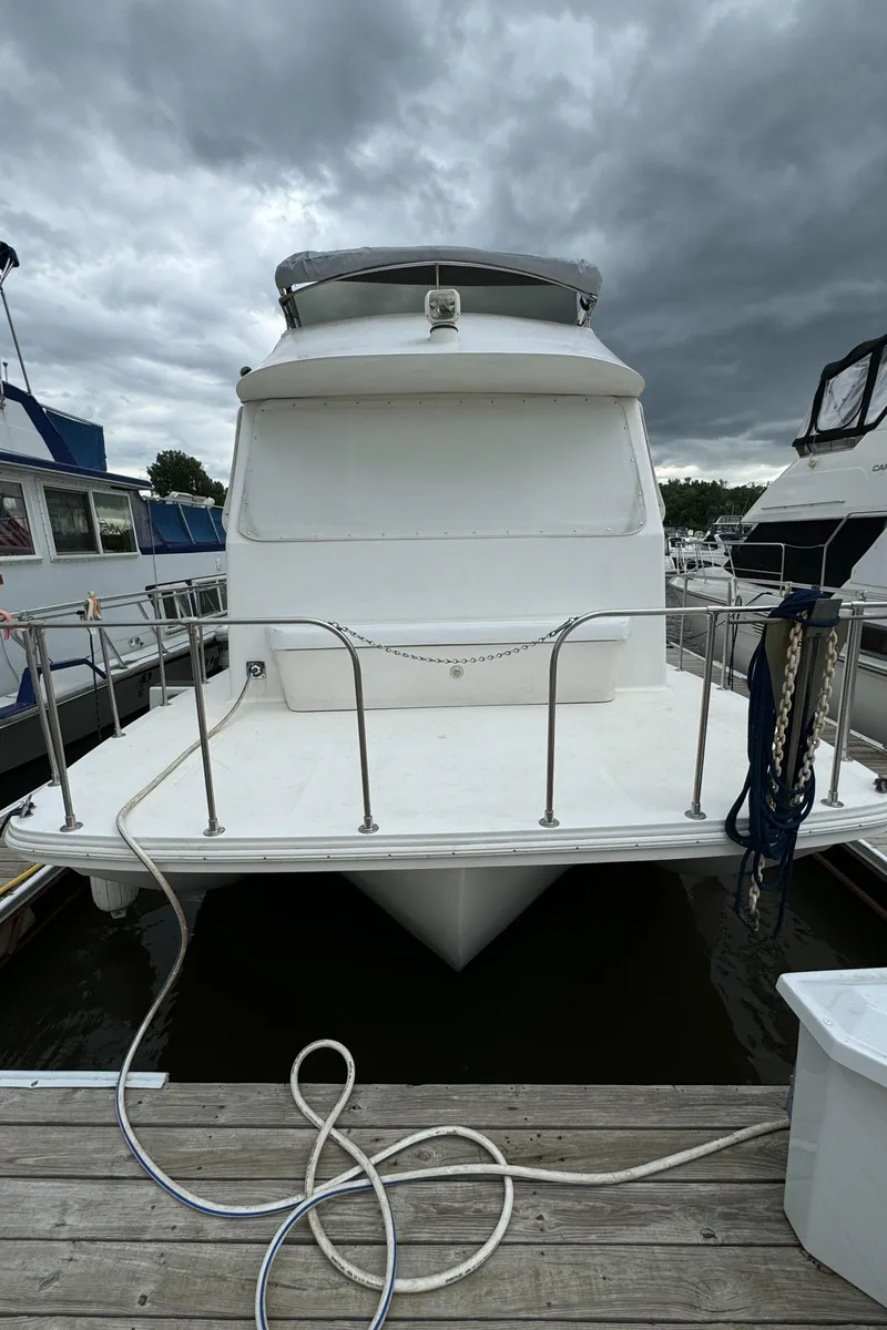 Slide: The Image of 2008 Holiday Mansion 37 houseboat docked under cloudy skies. - 8