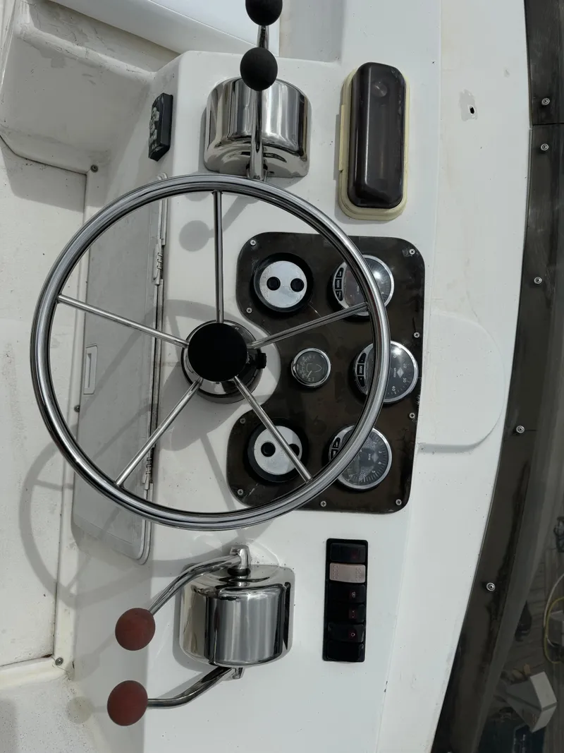 Slide: The Image of Steering wheel and controls of a 2008 Holiday Mansion 37 boat. - 9