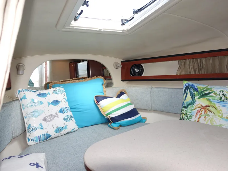 Slide: The Image of Cozy cabin interior of 2004 Sea Ray 280 Sundancer with colorful cushions and skylight. - 12