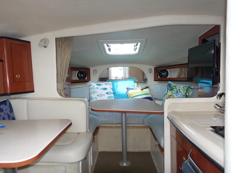 Slide: The Image of Interior of 2004 Sea Ray 280 Sundancer with cozy seating and modern amenities. - 21