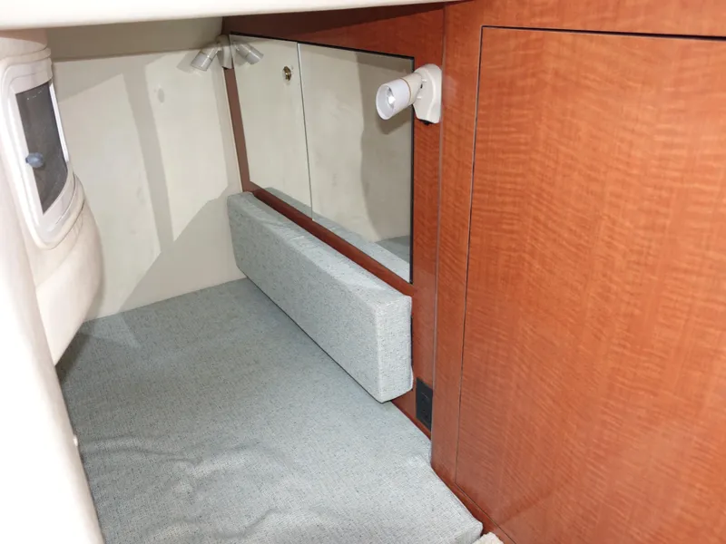 Slide: The Image of Interior cabin of 2004 Sea Ray 280 Sundancer with wood paneling and mirror. - 22