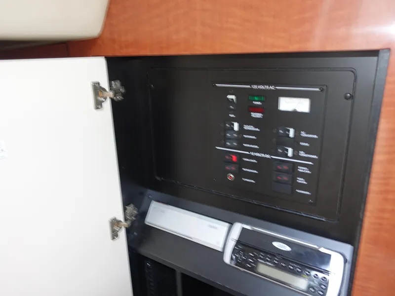 Slide: The Image of Electrical panel and stereo system in 2004 Sea Ray 280 Sundancer boat interior. - 24