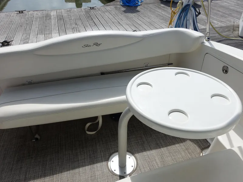 Slide: The Image of 2004 Sea Ray 280 Sundancer boat interior with seating and round table. - 26