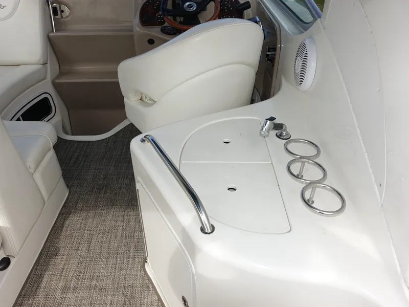 Slide: The Image of Interior of 2004 Sea Ray 280 Sundancer boat with white seating and helm. - 4