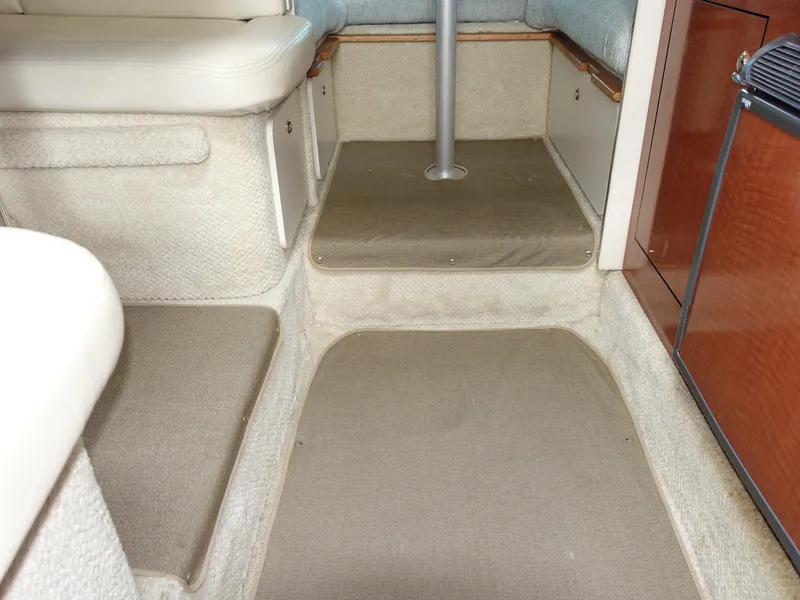 Slide: The Image of Interior cabin of 2004 Sea Ray 280 Sundancer with beige carpeting and seating. - 8