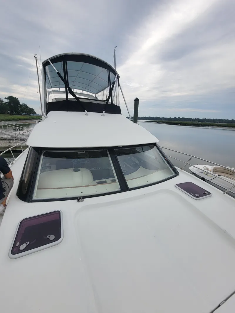 Slide: The Image of 2003 Robertson & Caine Lion 46 yacht on calm water under cloudy sky. - 12