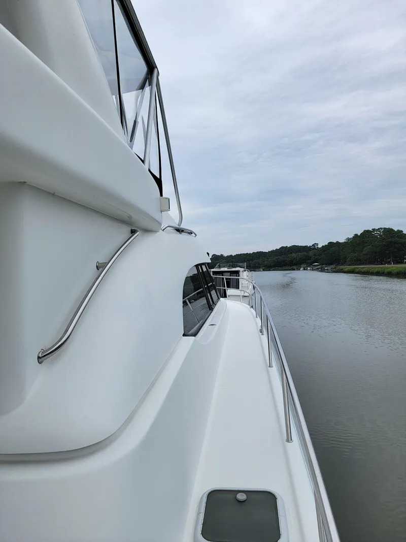 Slide: The Image of Side view of 2003 Robertson & Caine Lion 46 yacht on calm water. - 18