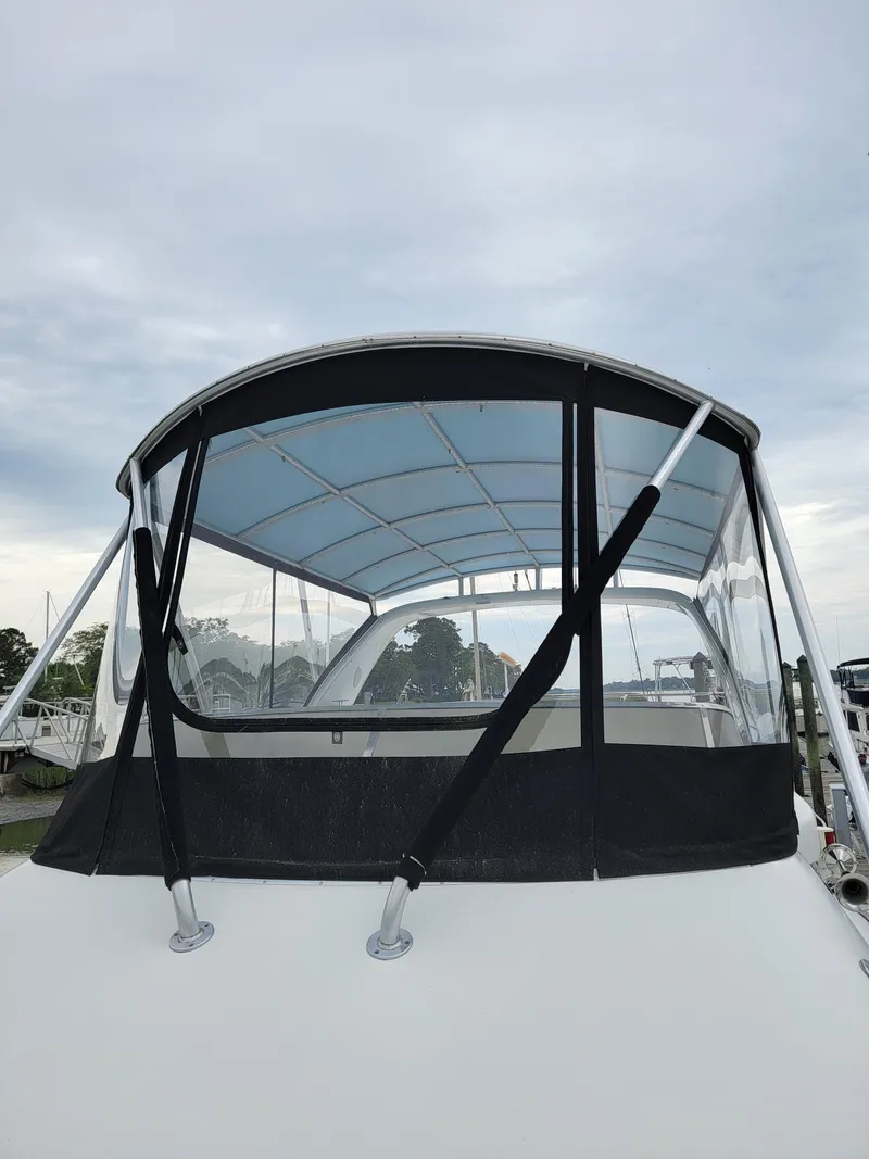 Slide: The Image of 2003 Robertson & Caine Lion 46 boat with canopy under cloudy sky. - 19