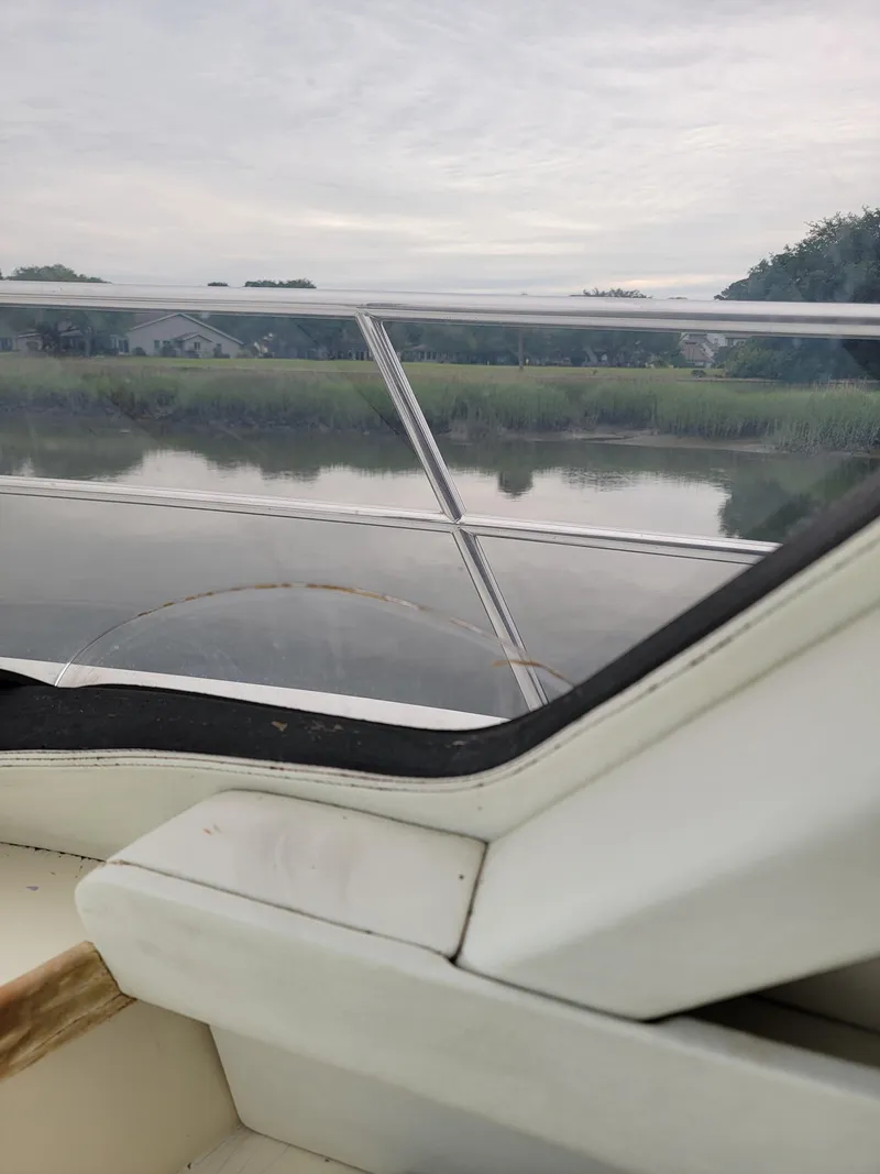 Slide: The Image of View from 2003 Robertson & Caine Lion 46 boat, overlooking serene river and lush greenery. - 24