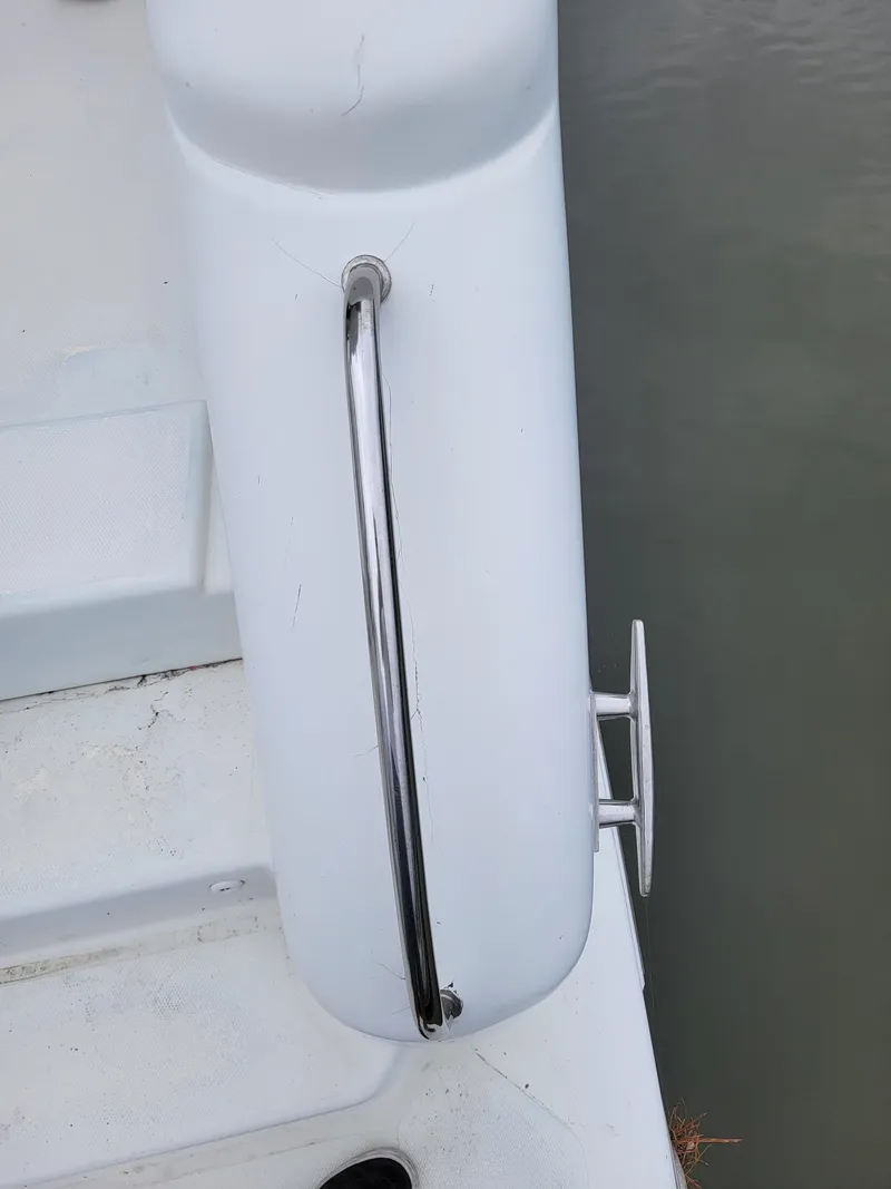 Slide: The Image of Close-up of a 2003 Robertson & Caine Lion 46 boat railing and cleat. - 28