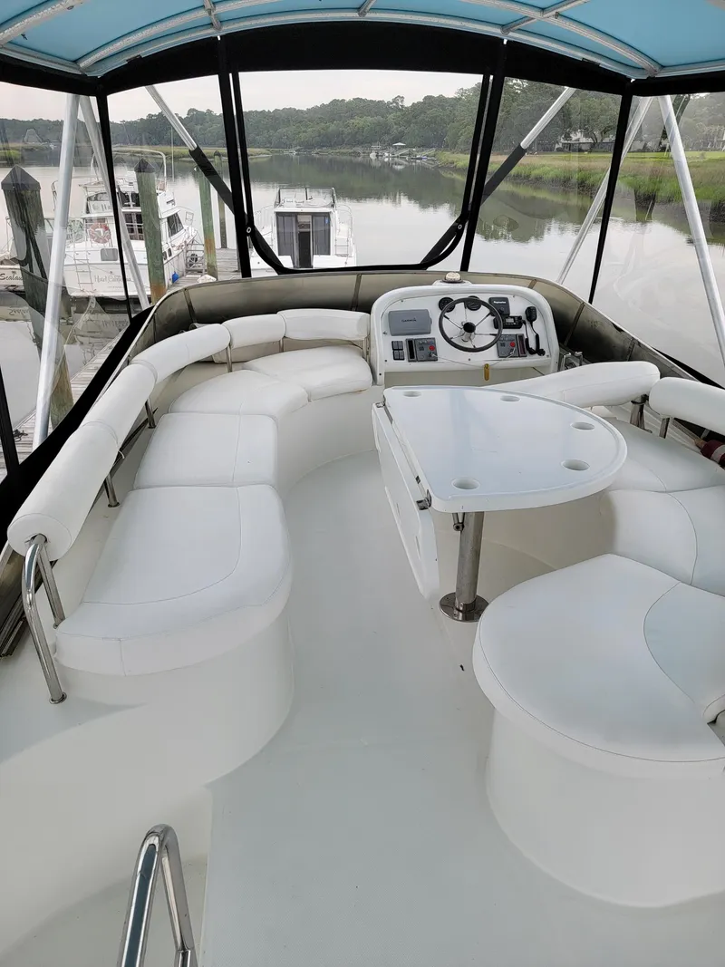 Slide: The Image of Luxurious 2003 Lion Robertson & Caine Lion 46 yacht interior with plush seating and helm. - 34