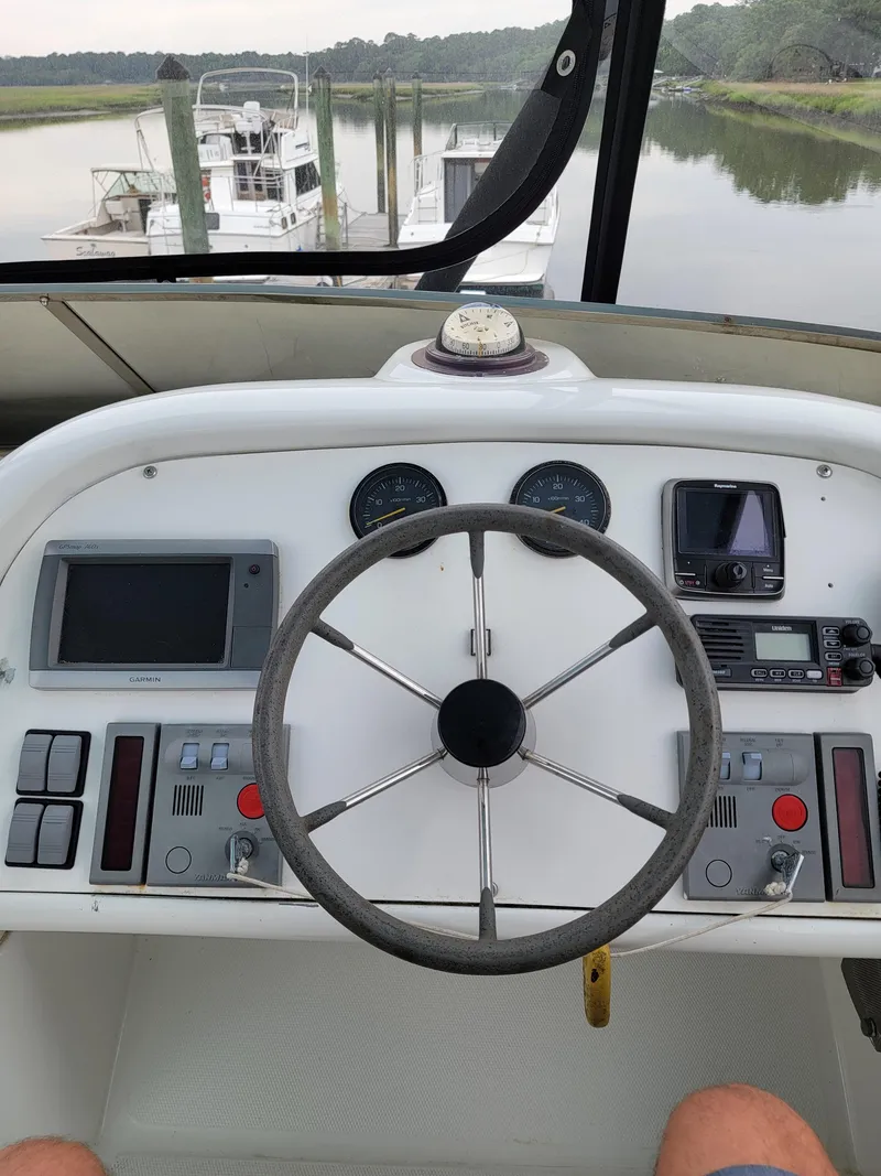 Slide: The Image of Cockpit of 2003 Robertson & Caine Lion 46 catamaran with steering wheel and navigation instruments. - 36