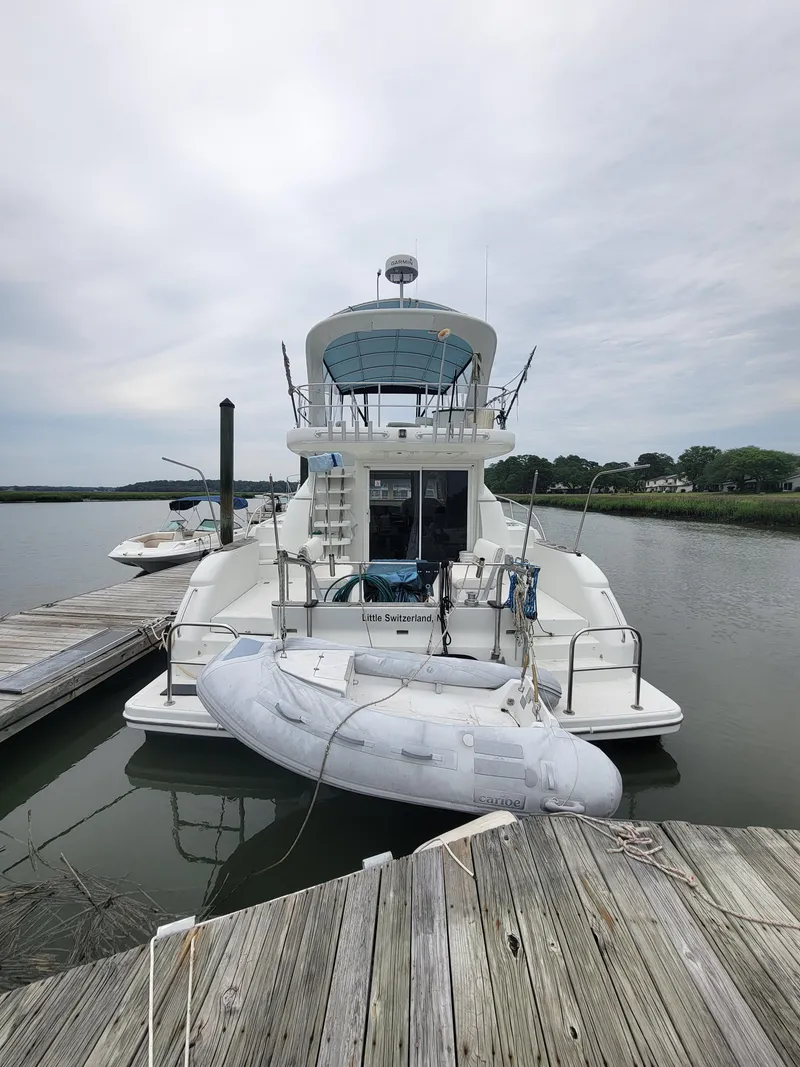 Slide: The Image of 2003 Robertson & Caine Lion 46 yacht docked with inflatable boat. - 4