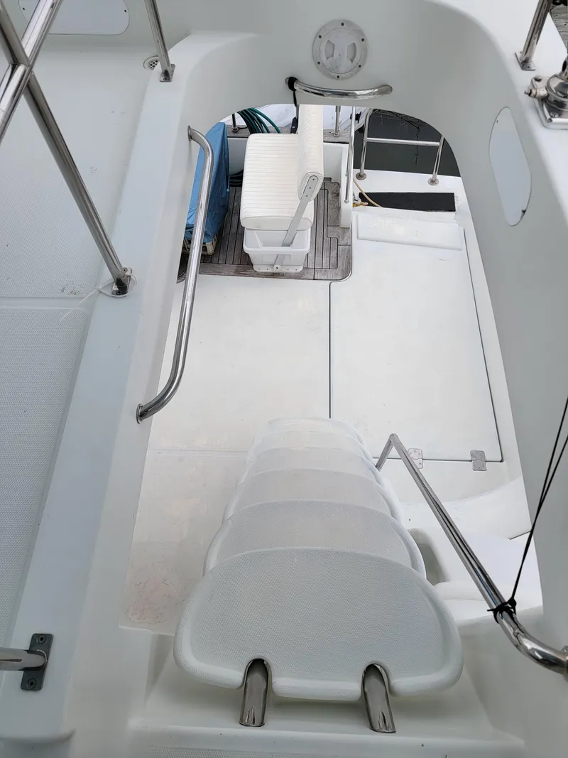 Slide: The Image of Interior view of 2003 Lion Robertson & Caine Lion 46 yacht, featuring white seating and sleek design. - 43