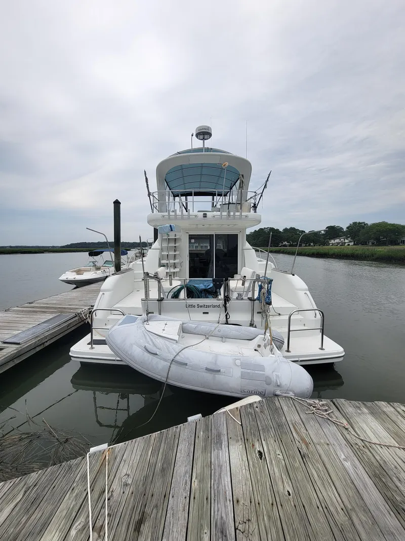 Slide: The Image of 2003 Robertson & Caine Lion 46 yacht docked with inflatable boat. - 5