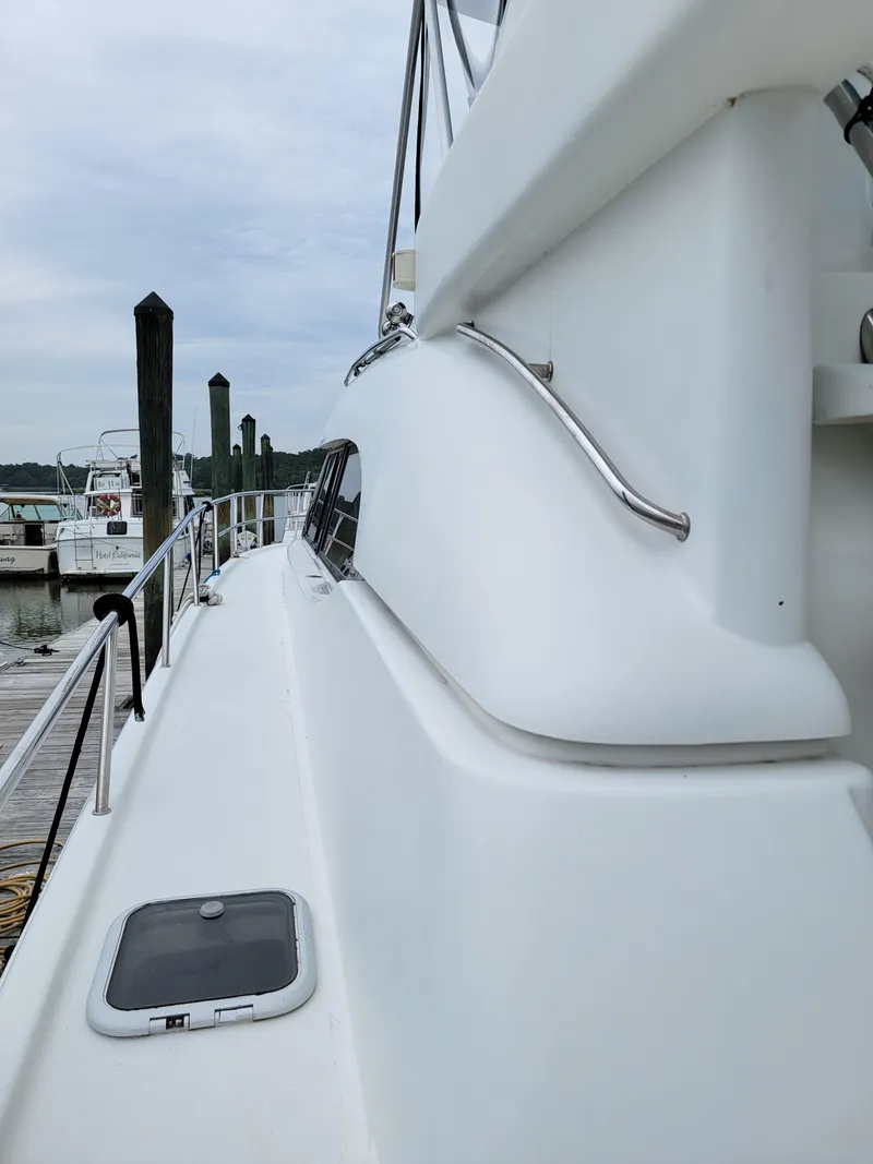 Slide: The Image of Side view of 2003 Robertson & Caine Lion 46 yacht docked at marina. - 8