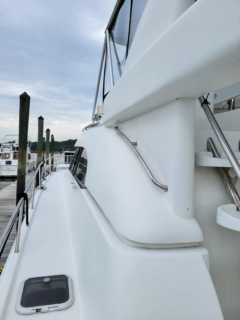 Slide: The Image of Side view of 2003 Robertson & Caine Lion 46 yacht docked at marina. - 9