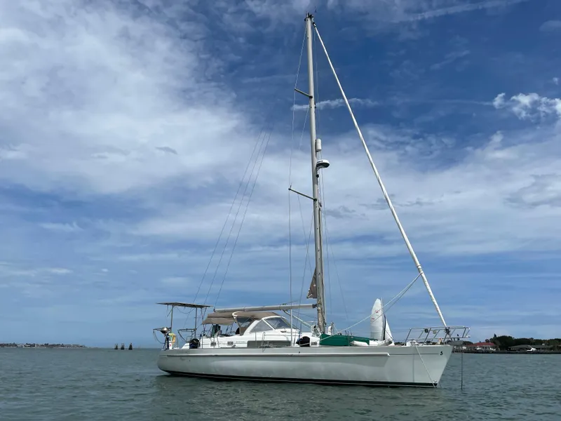 The Image of 2001 Beneteau Oceanis 44 CC sailboat on calm water under a blue sky. - 0