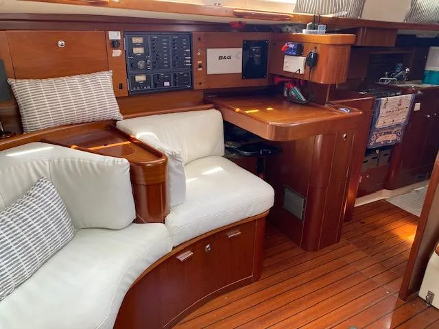 Slide: The Image of Luxurious interior of 2001 Beneteau Oceanis 44 CC sailboat with wood finish and white seating. - 12