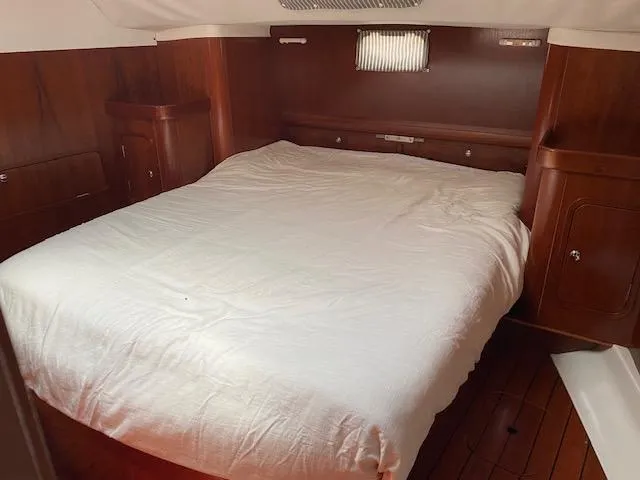 Slide: The Image of Cozy cabin interior of 2001 Beneteau Oceanis 44 CC with wooden finish and comfortable bed. - 17