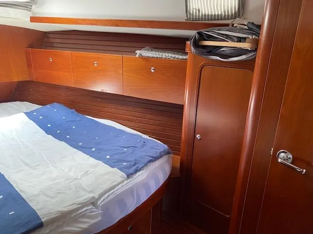 Slide: The Image of Cozy cabin interior of 2001 Beneteau Oceanis 44 CC with wooden finish and bed. - 19