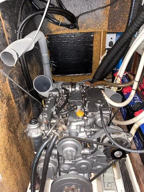 Slide: The Image of Engine compartment of 2001 Beneteau Oceanis 44 CC sailboat, showcasing mechanical components and wiring. - 26