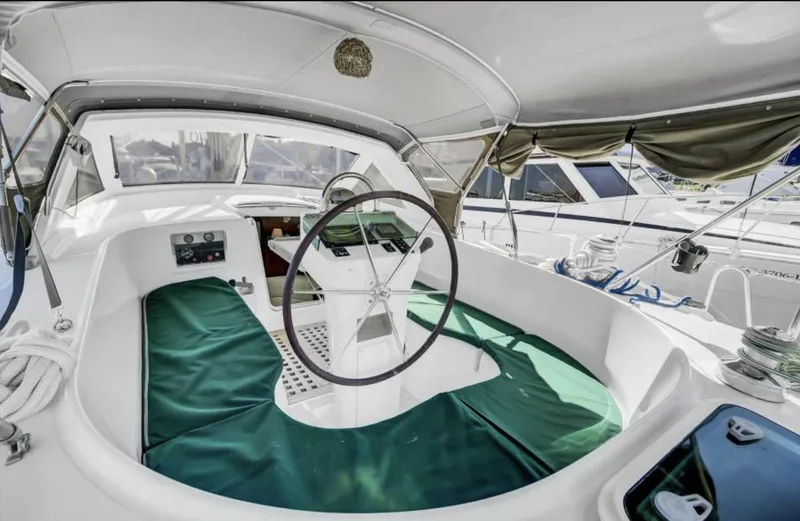 Slide: The Image of 2001 Beneteau Oceanis 44 CC cockpit with green seating and steering wheel. - 5