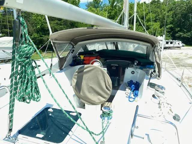 Slide: The Image of 2001 Beneteau Oceanis 44 CC sailboat with green ropes and covered cockpit, docked outdoors. - 6