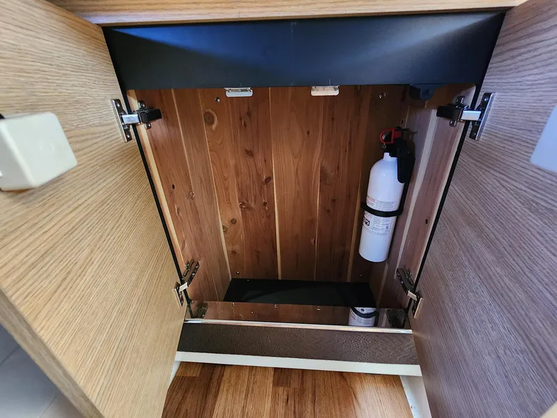 Slide: The Image of Open wooden cabinet with fire extinguisher inside, Chaparral 327 SSX 2012 model. - 12