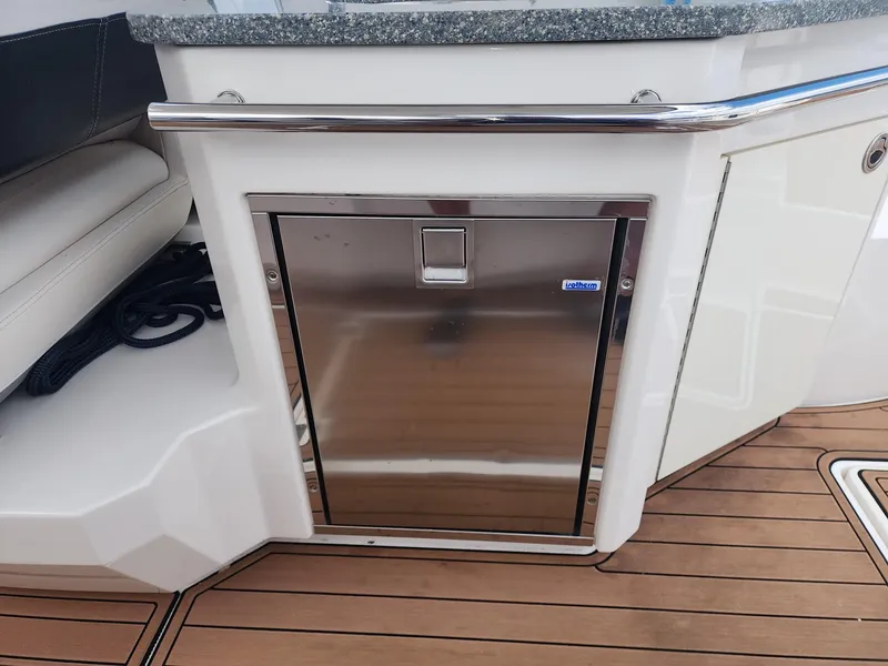 Slide: The Image of Stainless steel cabinet on 2012 Chaparral 327 SSX boat with wooden deck. - 14
