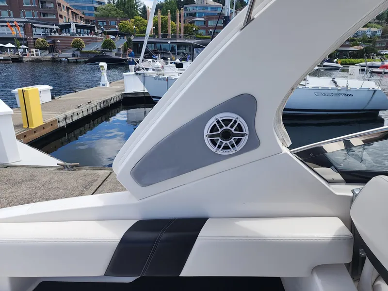 Slide: The Image of 2012 Chaparral 327 SSX boat interior with speaker, docked at marina. - 15